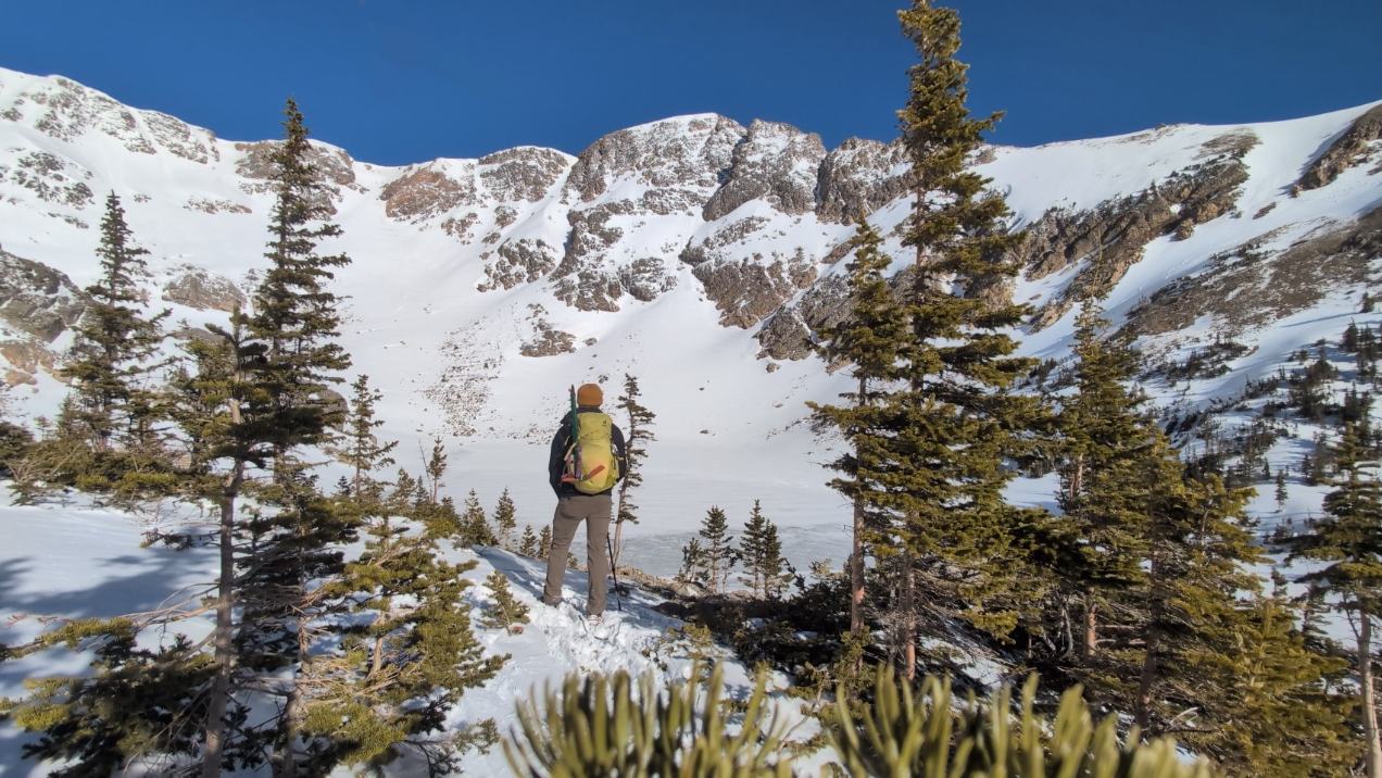 Winter mountain-scape with hiker looking into the distance