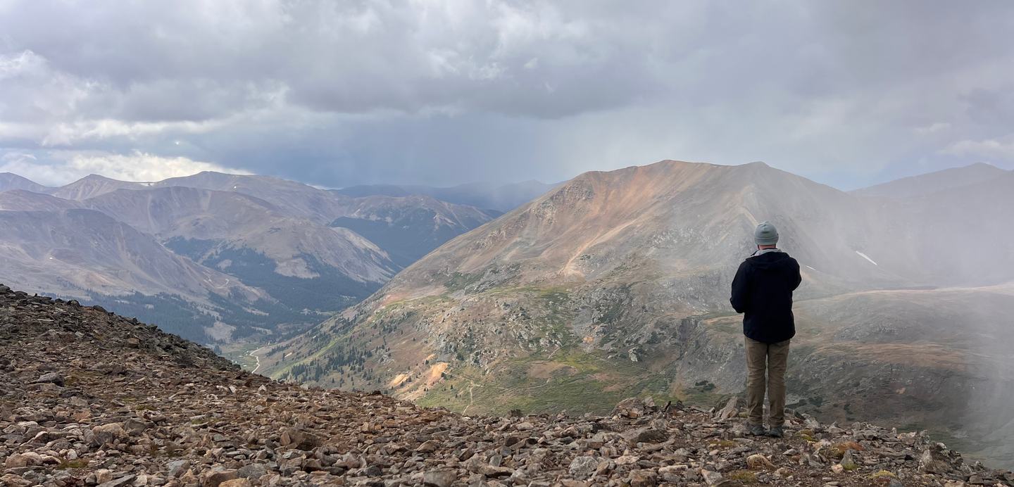 Foggy mountain overlook with hiker looking into the distance
